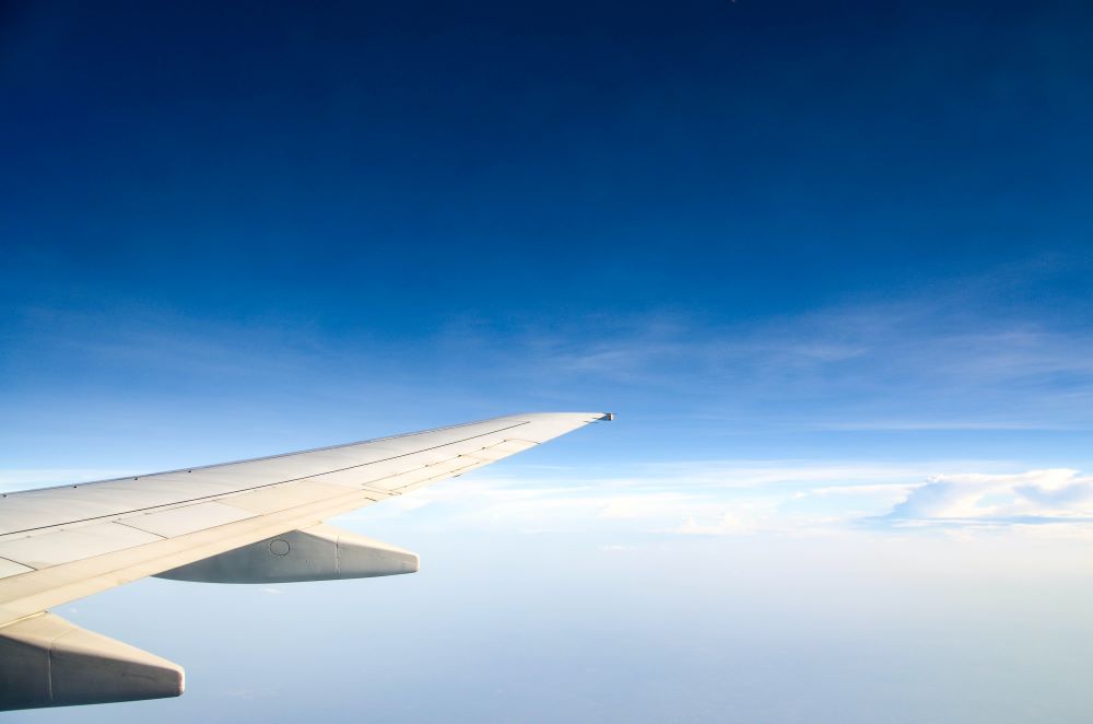 A private jet plane wing window view.